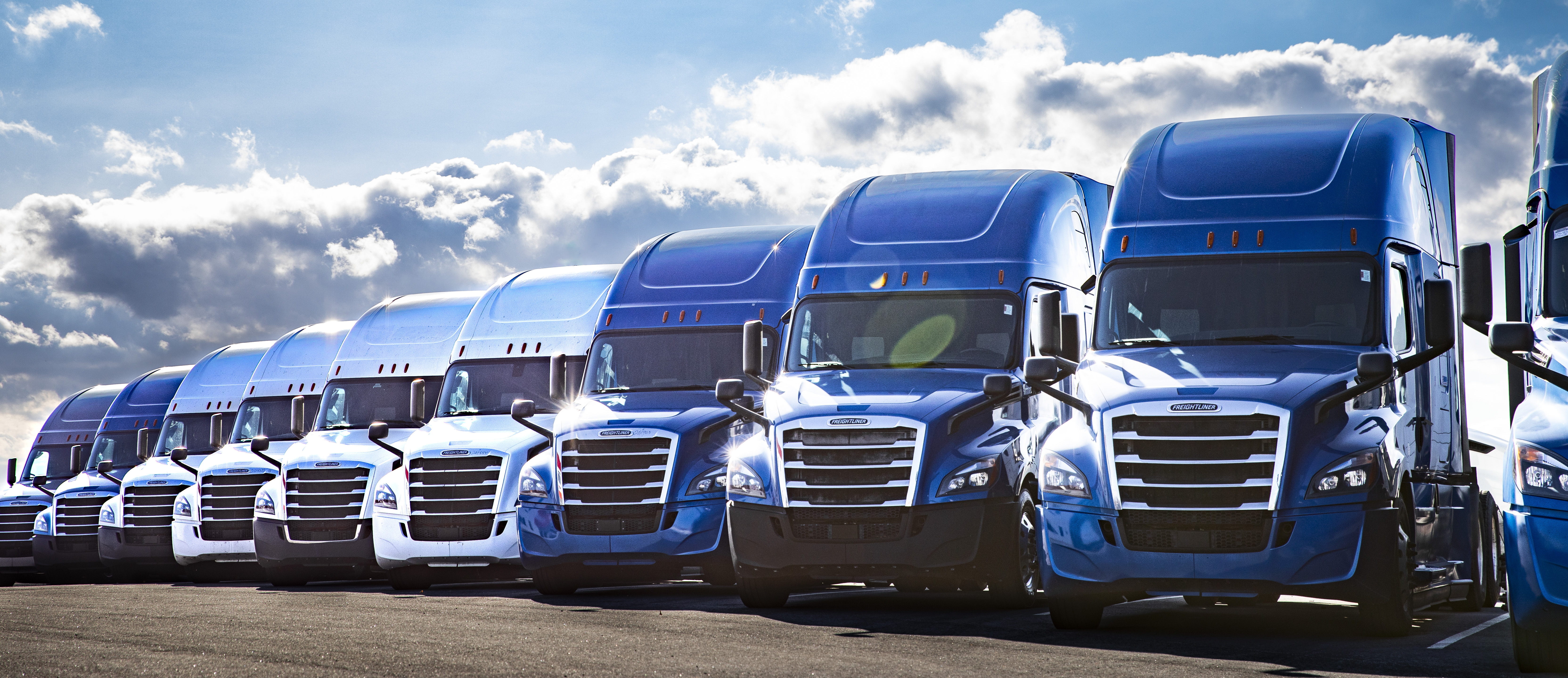 SelecTrucks dealership branding showing used Freightliner trucks backed by Freightliner